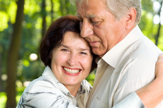 Woman Hugs Elderly Man
